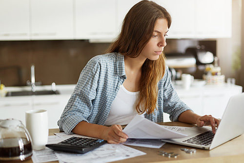 young woman with papers and laptop