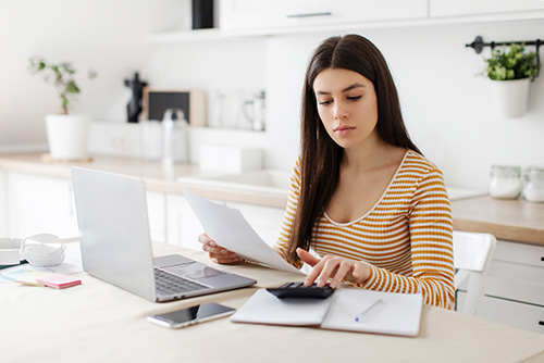 Student calculating future salary vs. college loan debt in 2025